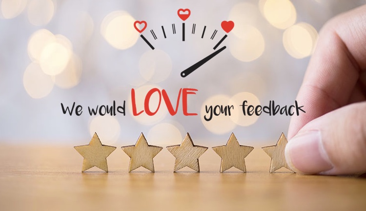 5 wooden stars placed on a table with "We would love your feedback"