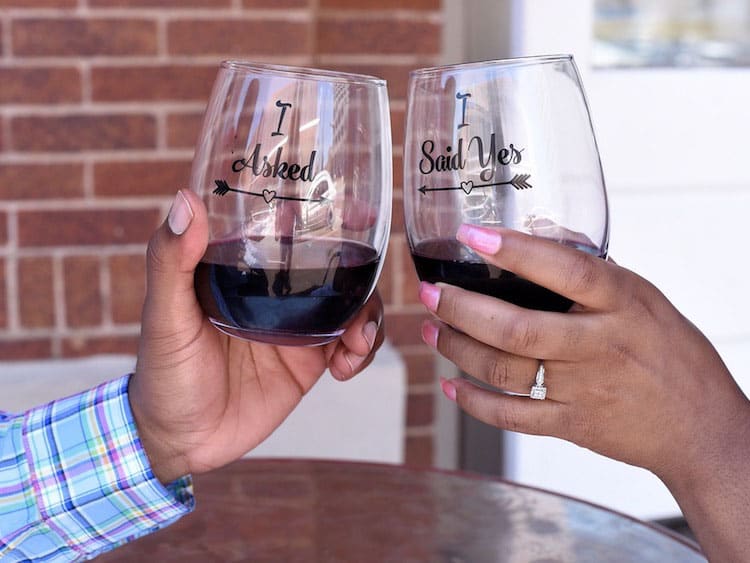 Engaged Couple Toasting With Matching Wine Glasses