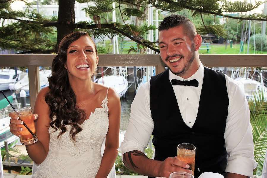 Newlyweds laughing and smiling at the bridal table